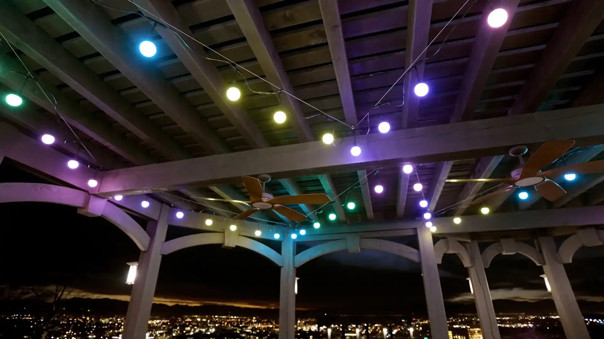 Multi-color Happy's patio lights at a party