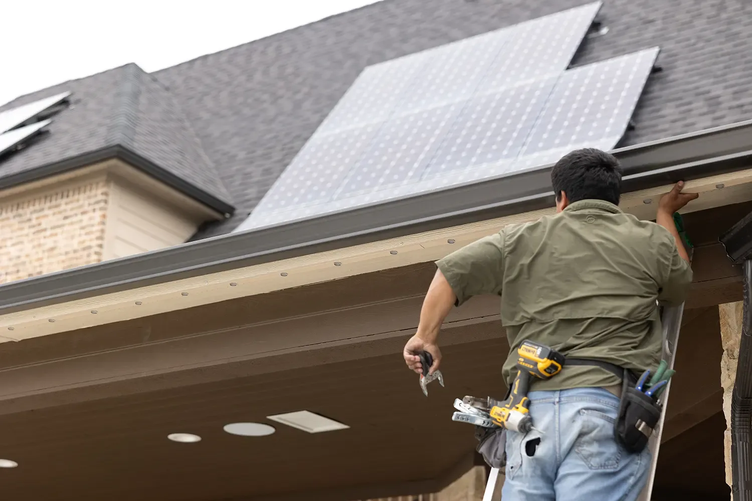 Happy's installer at work under an eave