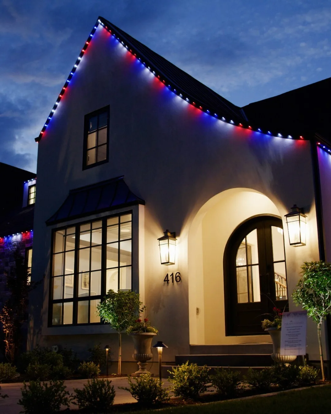 Home with Happy's eave lights in holiday colors