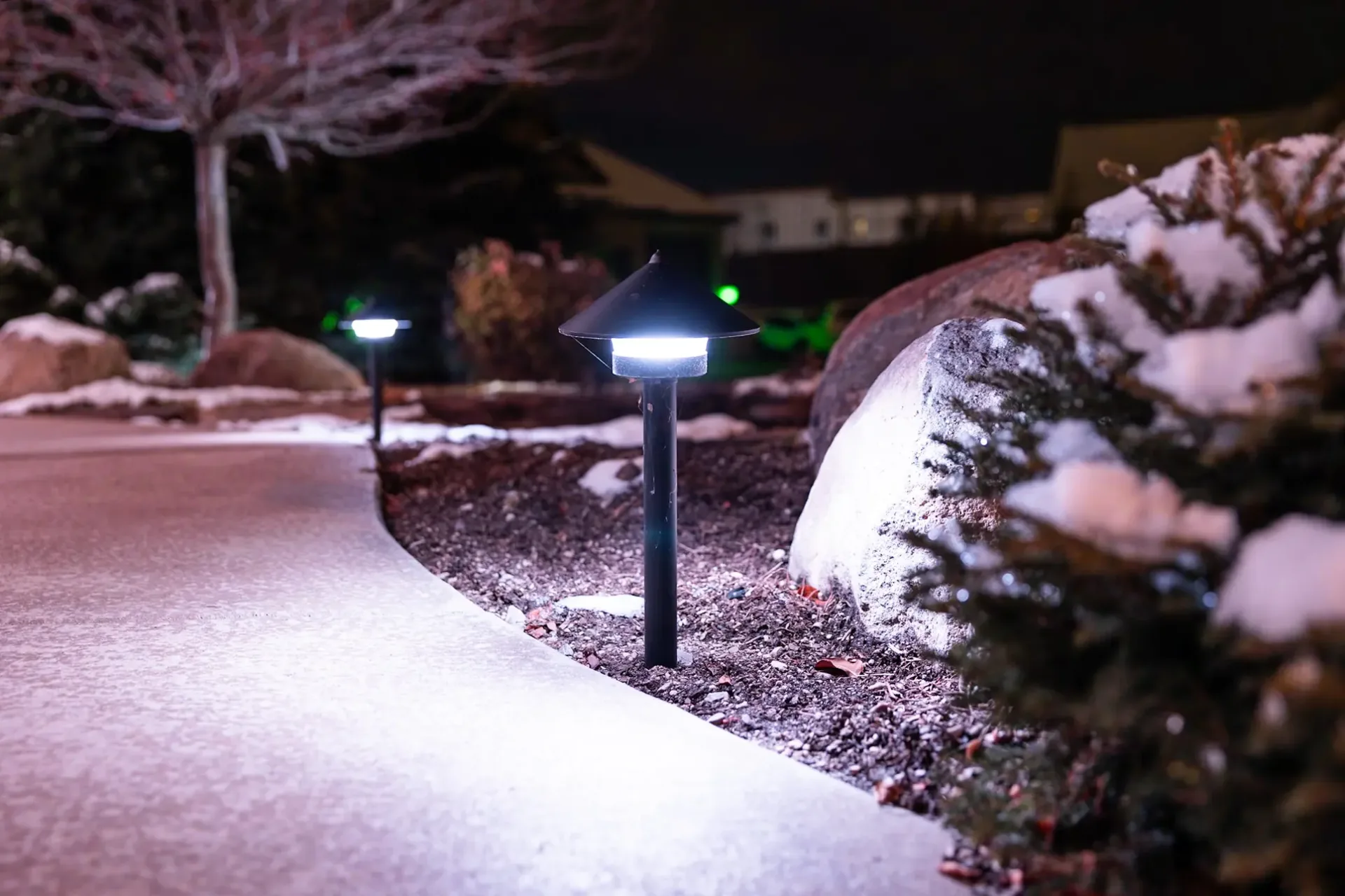 Bright white security lighting on a two-story home at night
