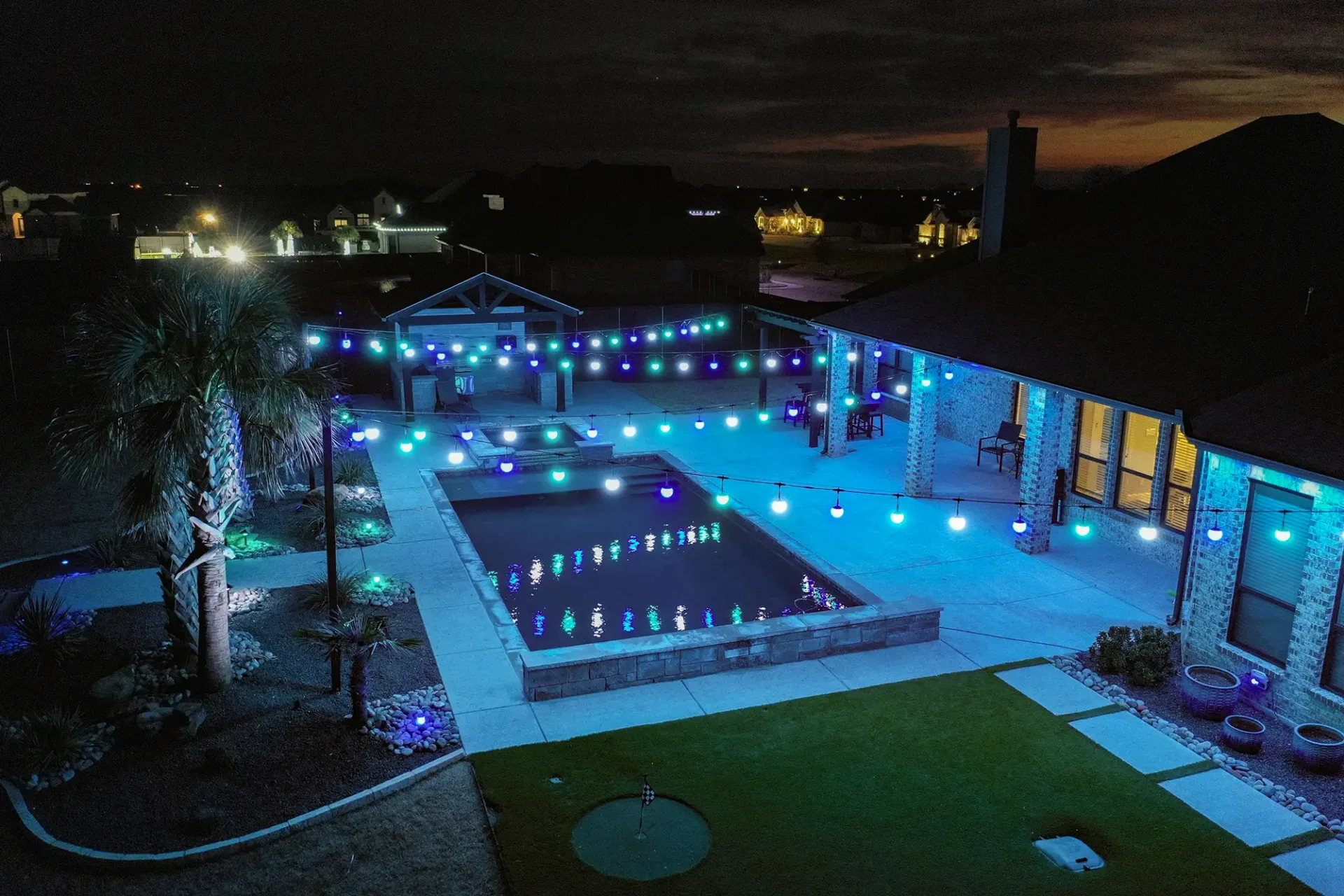 Patio lights over a backyard pool