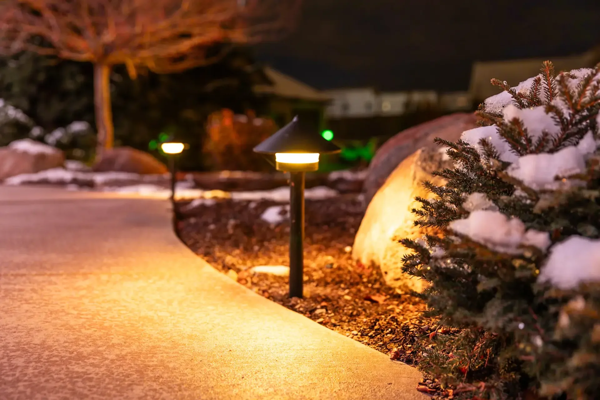 Happy's pathway lights glowing warm white along a walkway