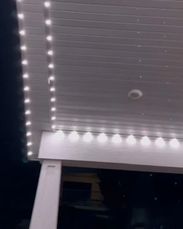 Close-up of Happy's track lights installed under a white eave